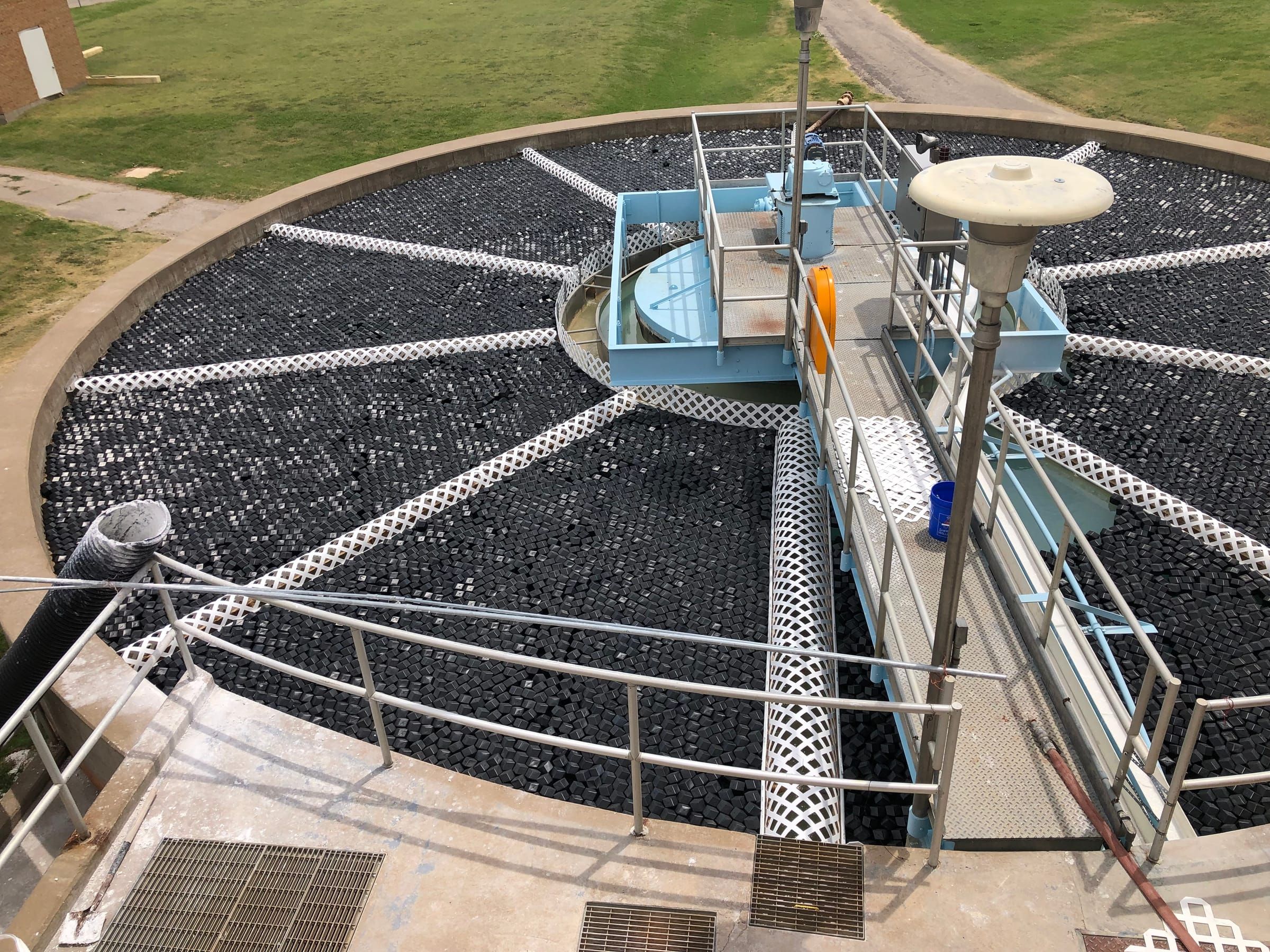 Rhombo Hexoshield hybrid rhombus-hexagon modular floating cover system on a large industrial chemical storage reservoir, achieving 98% evaporation reduction