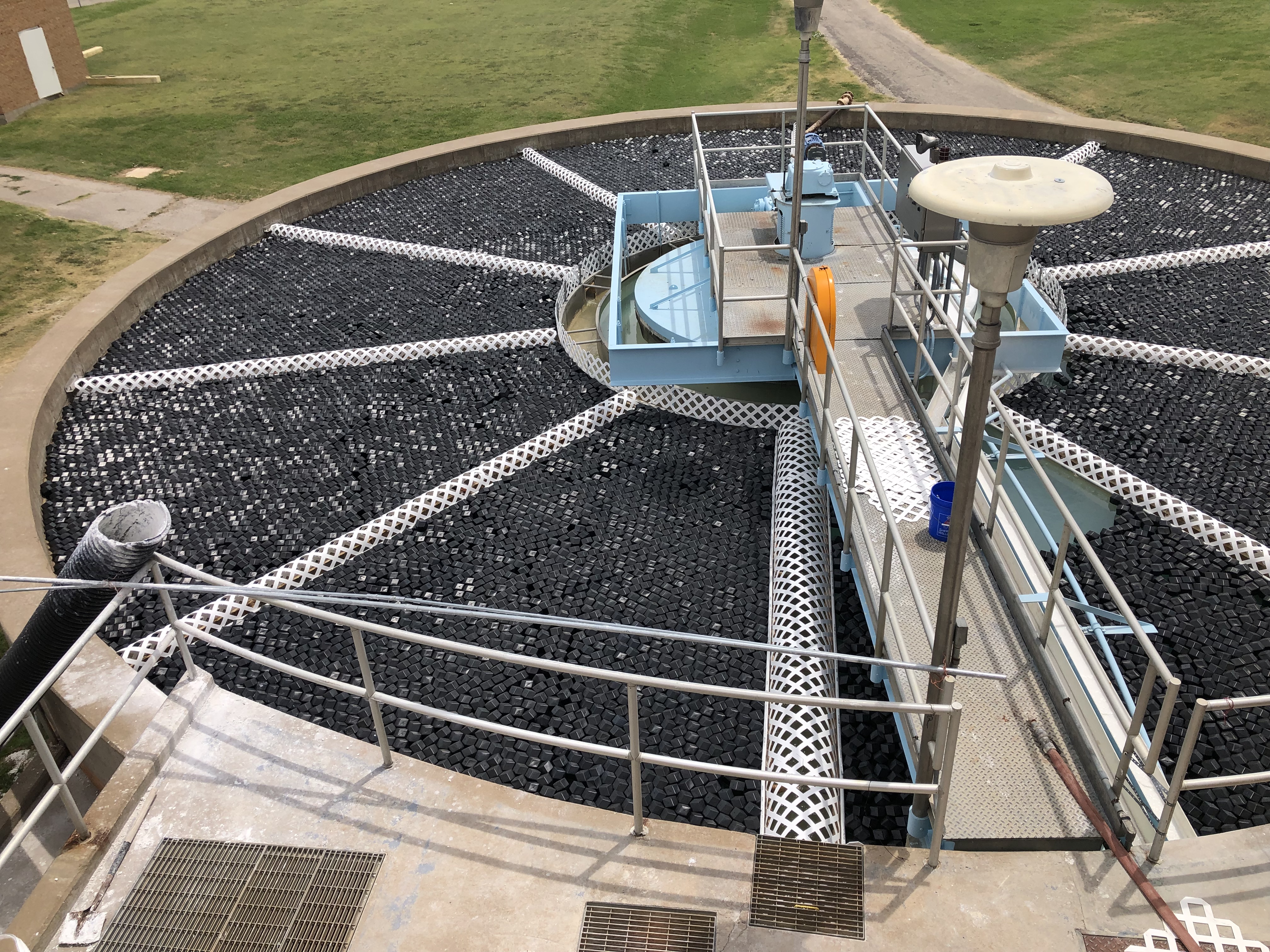 Rhombo Hexoshield 66 hybrid modular floating cover on a large industrial impoundment providing 25 lb per square foot buoyancy capacity, R-4 insulation, and 99% surface coverage