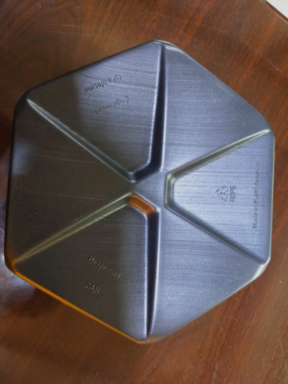Top-down view of a single AWTT Hexprotect hexagonal floating cover tile, showing the engineered HDPE geometry, ribbing, and ballast chamber design