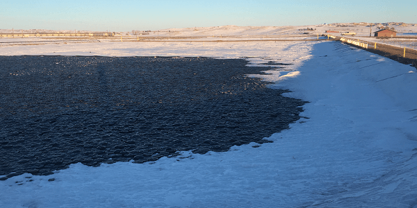 Hexprotect MAX R insulated floating cover system with 2.5-inch closed-cell foam insulation layer, designed for biogas digesters, dairy lagoons, and cold-climate industrial ponds