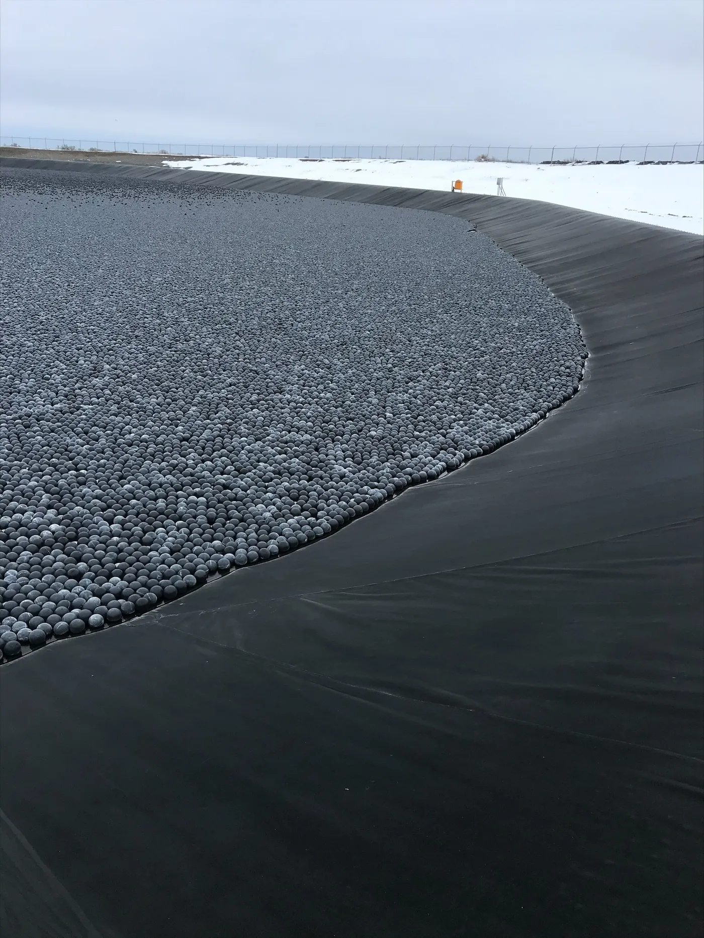 Armor Ball AQUA 275 spheres providing full surface coverage on a wind-exposed pond