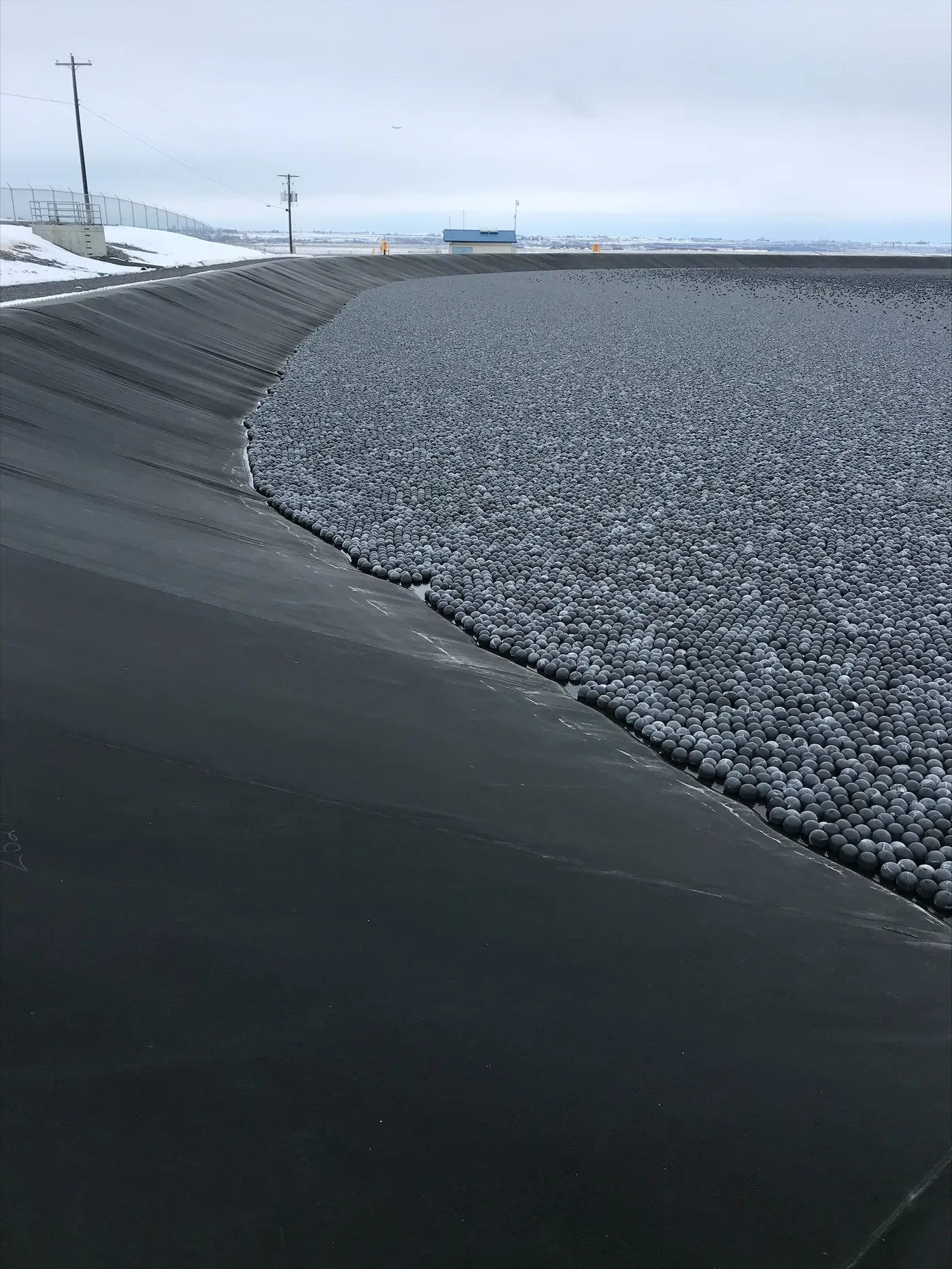Armor Ball AQUA water-filled wind-resistant floating covers on a large lined frac water pond