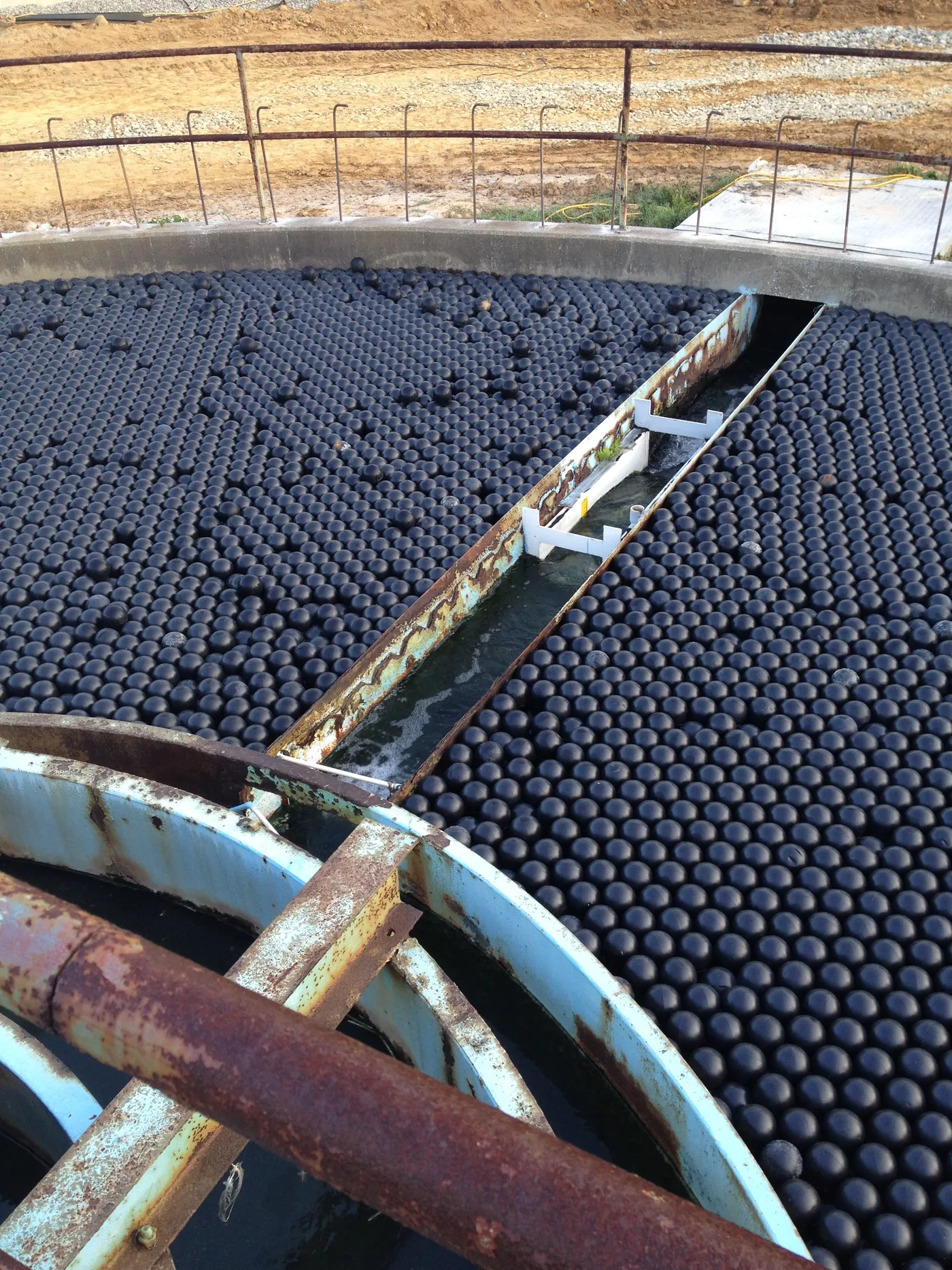 Armor Ball floating spheres covering a circular clarifier tank at a wastewater treatment plant
