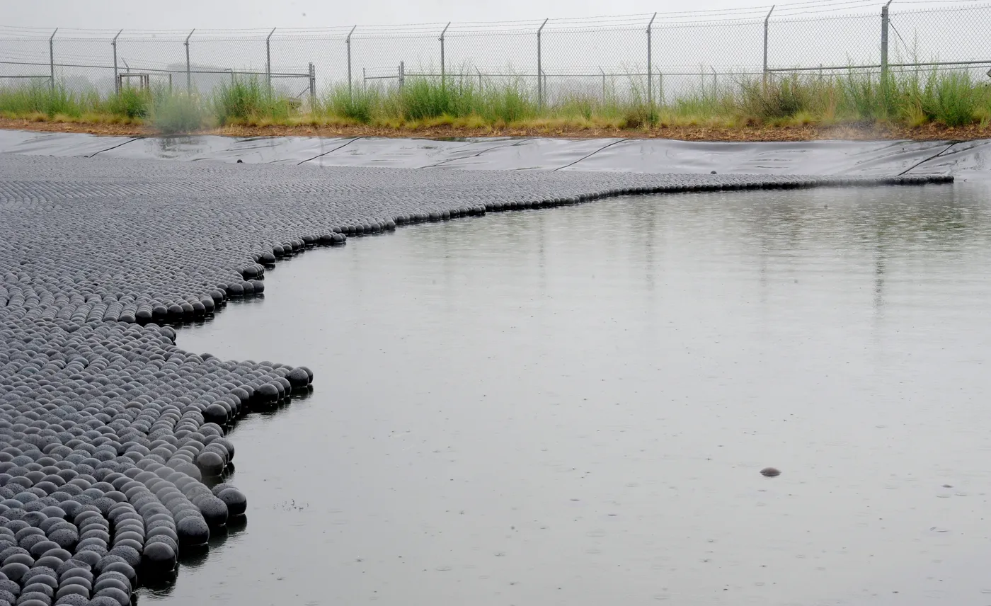 Armor Ball hollow HDPE shade balls covering the full surface of a ranch water storage pond to reduce evaporation and block algae