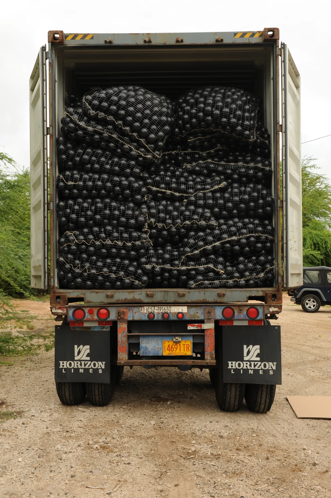 Palletized Armor Ball spheres bagged and loaded in a shipping container for worldwide delivery
