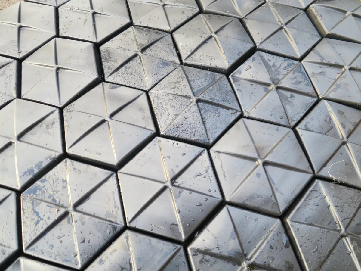 Close-up of interlocking Hexprotect AQUA hexagonal tiles achieving near-total surface coverage