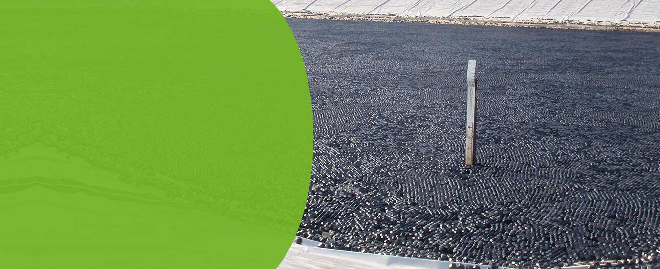 Rhombo Hexoshield 66 hybrid modular floating cover panels deployed across a large industrial impoundment providing 25 lb per square foot buoyancy, R-4 insulation, and 99% surface coverage